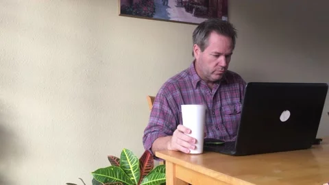 Man on Computer Drinking Morning Coffee Stock Footage 98013116