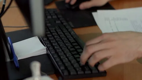 Man at the computer enters text using the keyboard Stock-Footage 71663065