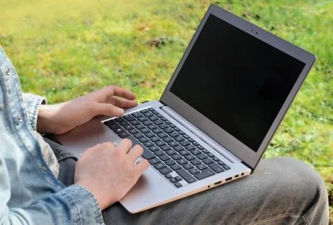 Man with computer in garden Stock Photos
