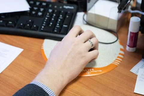 Man at the computer, hand on the mouse Stock Photos