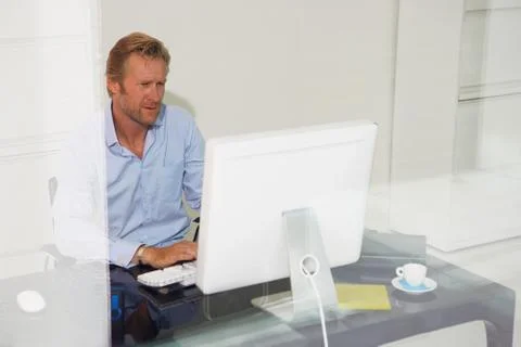 Man at computer with reflections. Stockfoto's