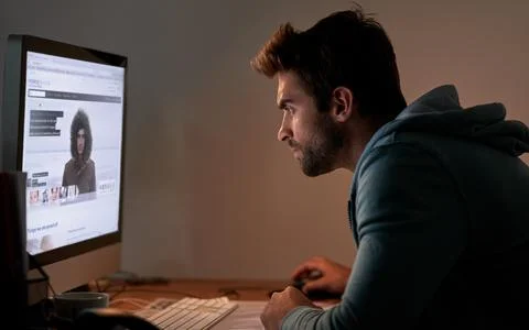 Man, computer screen and night for web design deadline, website development or Foto stock