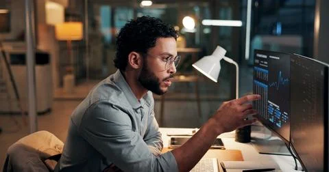 Man, computer screen and review with trading, graphs and stock market stats.. Stock Photos