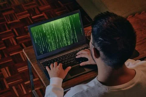Man with computer screen with green binary matrix binary 스톡 사진