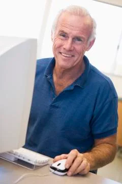 Man at computer smiling (high key) Stock Photos