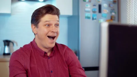 The man at the computer is surprised with joy Stock Footage 145135760
