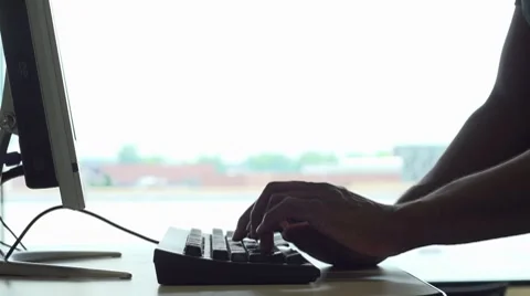 Man at computer terminal typing Stockbeeldmateriaal 8511185