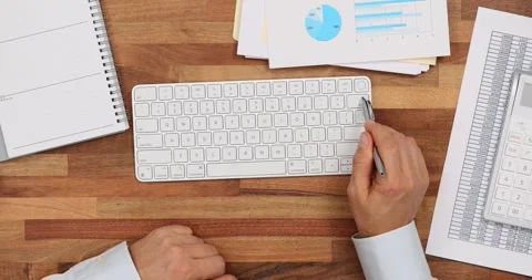 Man with computer user pen presses delete button on computer keyboard at Stock Footage 262792074