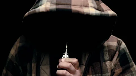 Man with concealed identity smoking a controversial vape is a health risk Stock Footage 69009927
