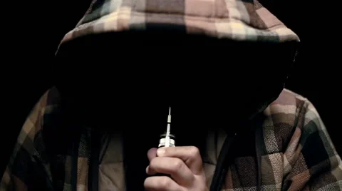Man with concealed identity smoking a controversial vape in slow motion Stock Footage 69009944