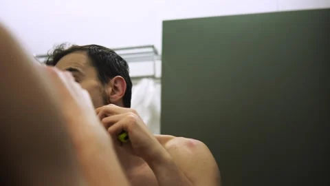 Man with concentrated expression preparing himself with grooming tools in calm Stock Footage 343956449