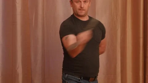 Man with concentrated look show techniques with a sword and bows 4k Stock Footage 45760099