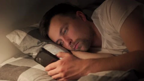 Man concentrated man chatting, typing message, looking at mobile mobile smart Video stock 145485380