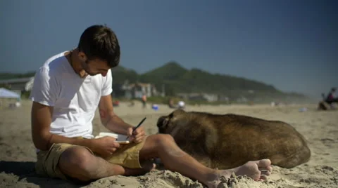 Man concentrates on his writing Stock Footage 54054380