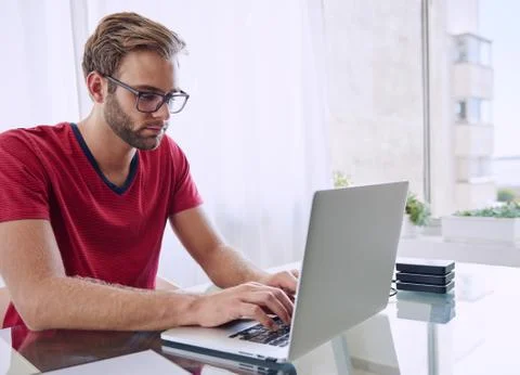 Man concentrating on getting his work done Stock Photos
