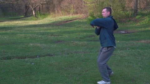 Man Conducts Training Karate in the Woods,performs Basic Kata of Karate in the Stock Footage 74694311