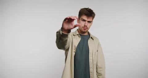 Man confidently communicates a message of pause and reflection through expr.. Stock-Footage 329112817