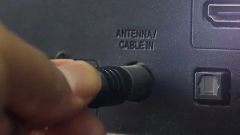 Man connecting an antenna cable to a television Stock Footage 344363502