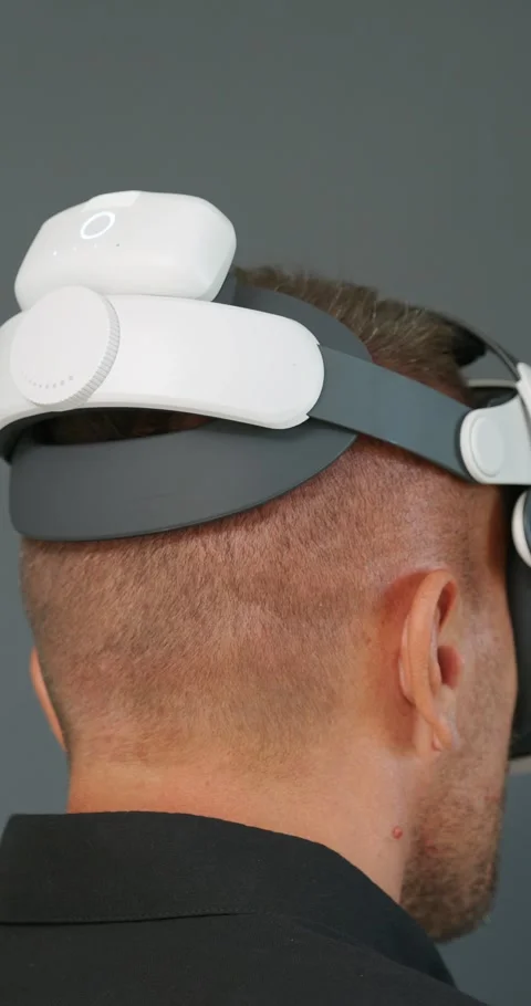 Man connecting battery on Virtual Reality headset. Back view. Stock Footage 257593038
