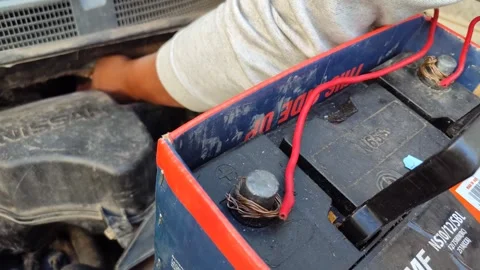 Man Connecting Cables to Jumpstart Car Stock Footage 310631304