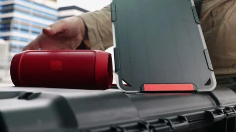 Man is connecting his smartphone with wireless speaker while being charging, Video stock 157590097