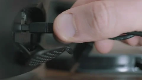 Man connecting a portable device to a computer via a usb port. Stock Footage 148394601