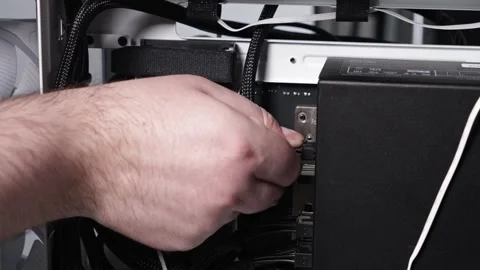 Man connecting power supply cables inside white PC case during computer ass.. Stock Footage 305673219
