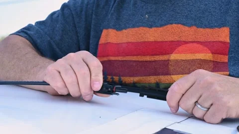 Man connecting solar panel connection cables on top of a camper Stock Footage 252751523