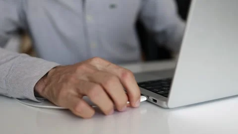 Man connecting usb-c cable to laptop at home office. Stock Footage 343938187
