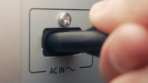 The man connects AC cable. AC input Stockbeeldmateriaal 84479224