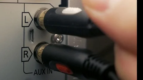 The man connects the AUX cable. Audio jack Stock Footage 84479276