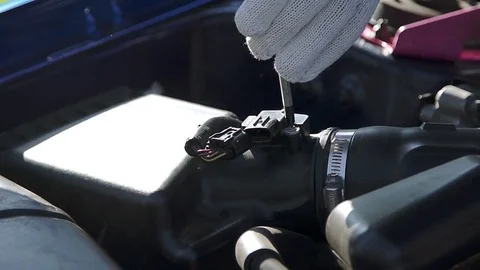 The man connects the connector to the sensor Stock Footage 73554663