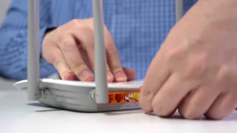 Man Connects Lan Cable to Router. Router Wireless. Close-up Stock Footage 150958918