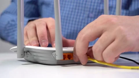 Man Connects Lan Cable to Router. Router Wireless. Close-up Stock Footage 150958998