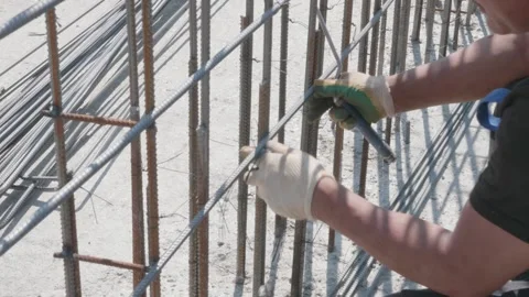 Man connects metal structure at construction site 10.06.2020 Stock Footage 132493166