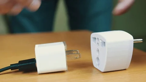 The man connects USB power supply unit to an adapter. Stock Footage 70605341