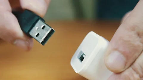 The man connects USB a wire to the port. Stock Footage 70604718