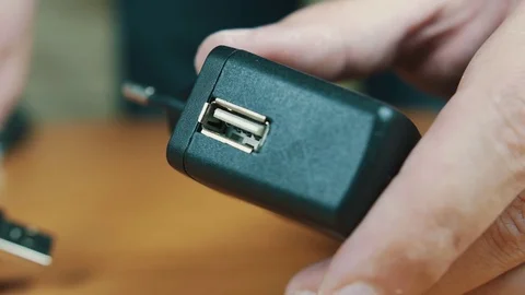 The man connects USB a wire to the port. Stock Footage 70605182