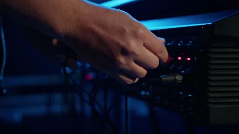 A man connects an XLR cable to a professional speaker Stock Footage 240903861