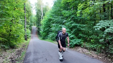 Man conquers forest trails while training with 50 kg backpack and climbing boots Stock Footage 344819413