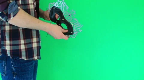 Man considers a mask for the masquerade Stock Footage 60745465