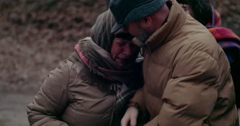 Man consoling distraught war refugee woman crying. Stock Footage 175798357
