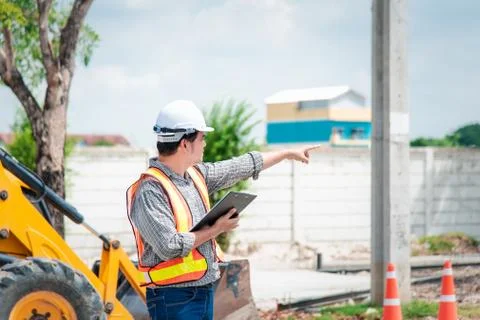 Man construction engineer at construction site 스톡 사진