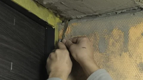 Man construction worker applies material using putty knife Video stock 304409106