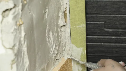 Man construction worker applies plaster to wall during renovation 스톡 동영상 304408946
