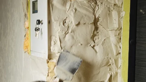 Man construction worker applies plaster with trowel on wall Stock Footage 304410506