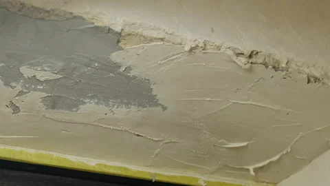 Man construction worker applies putty over plastered surface Stock Footage 304421541