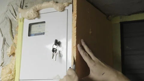 Man construction worker cuts insulation material on walls Stock Footage 304408868