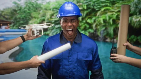 Man construction worker in hardhat receives rolled blueprint and faces dron.. Vídeos de archivo 339133357
