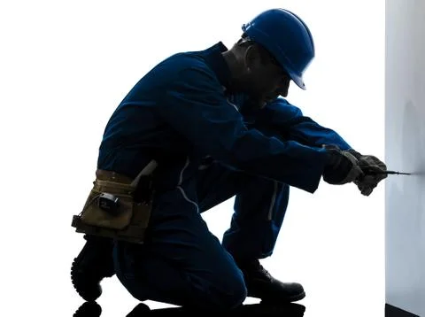 Man construction worker screwdriving silhouette Stock Photos